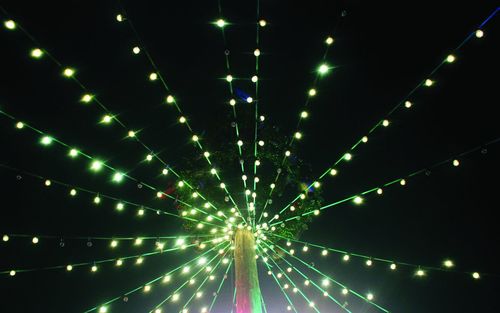 Low angle view of decoration against sky at night