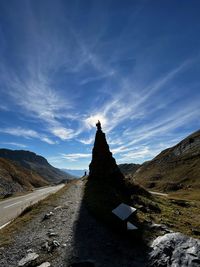 Road by mountain against blue sky