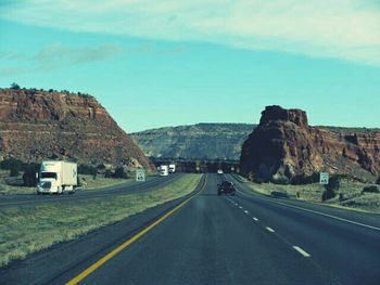 Empty road leading towards mountains