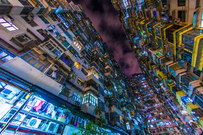 Low angle view of illuminated buildings in city at night