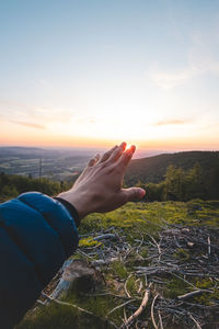 Cropped image of man against sky during sunset