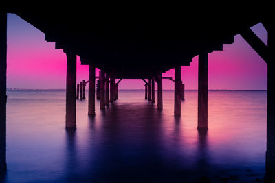 Silhouette of pier on sea against sky during sunset