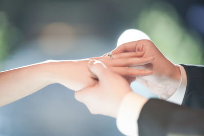 Bride and groom exchanging rings during wedding at night