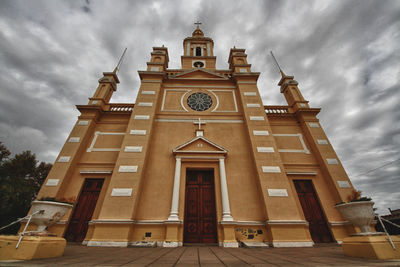 Exterior of church against cloudy sky