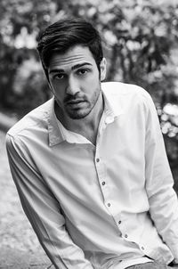 Portrait of young man sitting outdoors