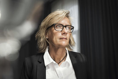 Mature businesswoman standing in hotel room