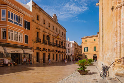 Street amidst buildings in city against sky