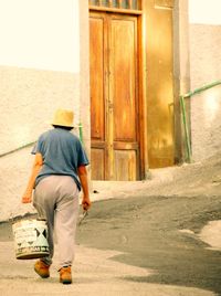 Rear view of man walking in building