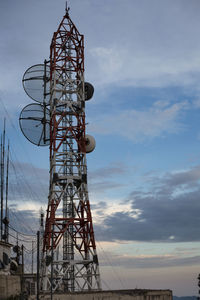 Low angle view of communications tower against sky