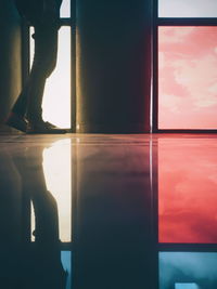 Low section of person standing by window