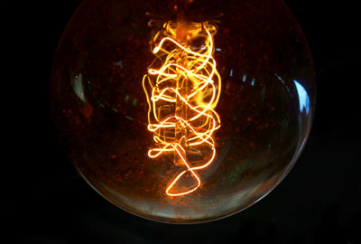Close-up of illuminated light bulb