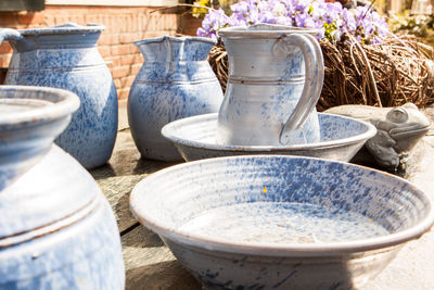 View of basin and jugs on table with flowers