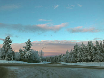 Scenic view of snow covered land against sky