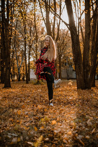 Woman walking in forest during autumn