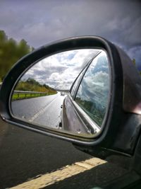 Reflection of car on side-view mirror