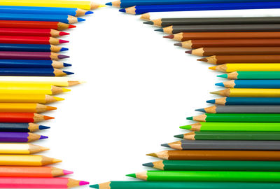 Close-up of colored pencils against white background