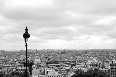 Cityscape against cloudy sky