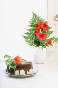 Close-up of red roses in vase on table