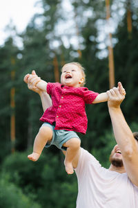 Father and son play together in the park and have fun