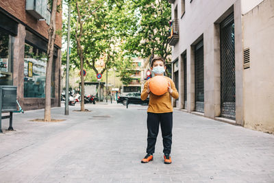 Rear view of woman walking on street in city