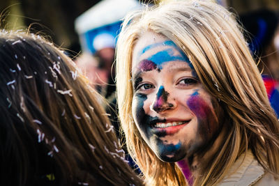 Portrait of smiling young woman with face paint