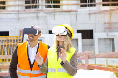 Two persons with virtual reality glasses at construction site