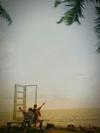 People at beach against sky