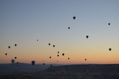 Hot air balloons flying in sky during sunset