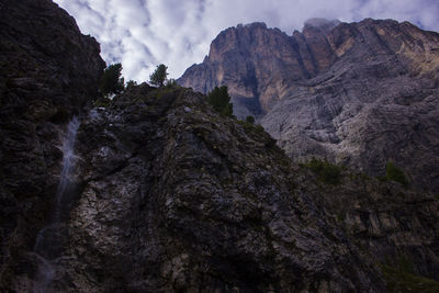 Low angle view of rocky mountains against sky