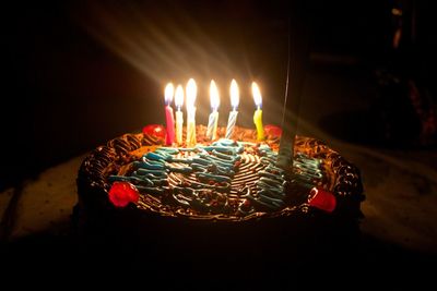 Close-up of lit candles on birthday cake