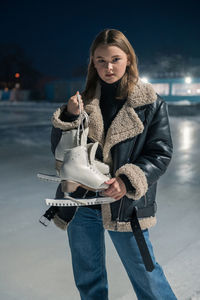 Portrait of young woman standing against sky