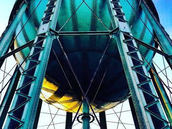 Low angle view of metallic structure against blue sky