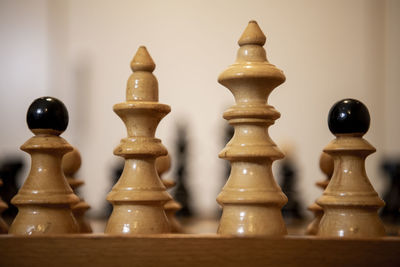 Close-up of chess pieces on table