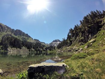 Scenic view of lake against sky on sunny day