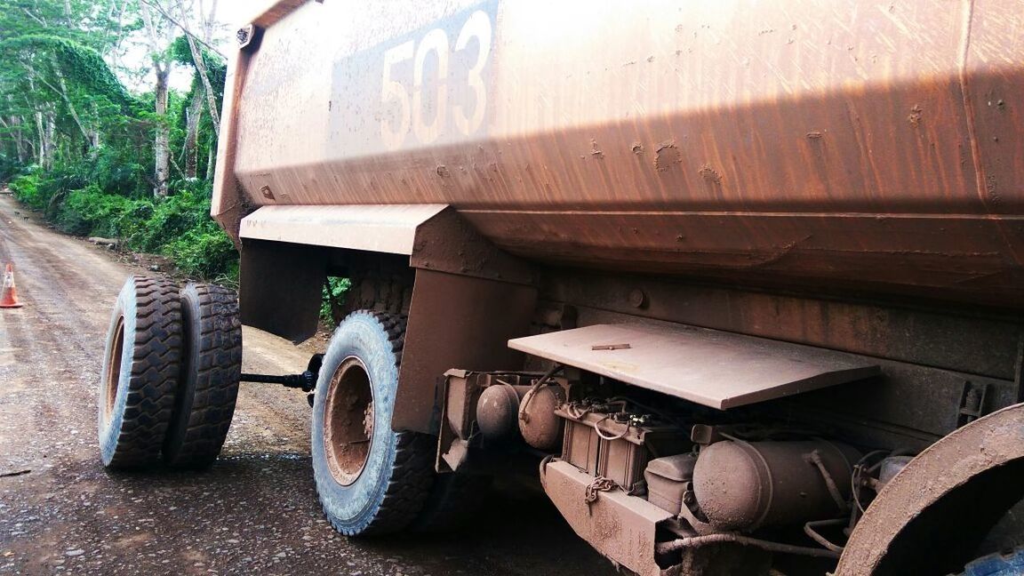 transportation, mode of transportation, wheel, land vehicle, day, tire, no people, motor vehicle, truck, nature, machinery, dirt, land, outdoors, tree, commercial land vehicle, metal, stationary, car, road