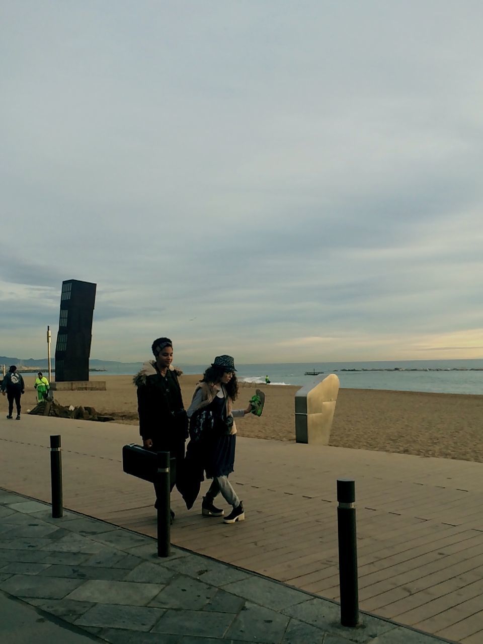 PEOPLE ON BEACH AGAINST SKY