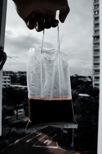 Close-up of hand holding drink in glass