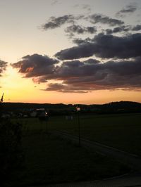 Scenic view of field against sky during sunset