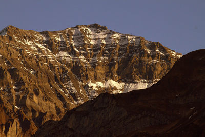 Low angle view of rock formation against clear sky