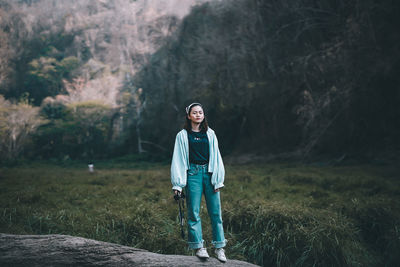 Portrait of teenage girl standing on field
