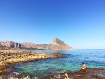 Scenic view of sea against clear blue sky