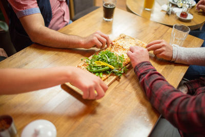 Cropped image of people having food in restaurant