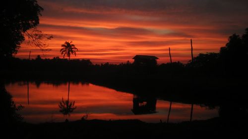 Scenic view of lake against orange sky