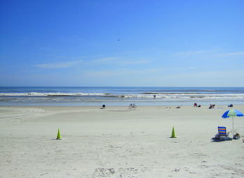 Scenic view of beach against blue sky