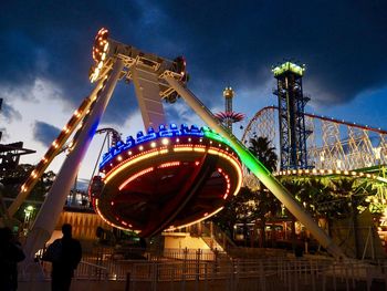 Illuminated ferris wheel at night
