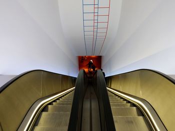 Rear view of man on escalator