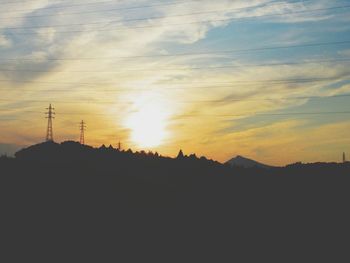 Silhouette trees against sky during sunset