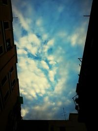 Low angle view of building against cloudy sky