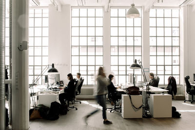 Male and female professional coworkers working in office