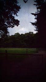 Scenic view of field and trees against sky